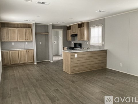 A kitchen with wooden cabinets and a countertop is available.