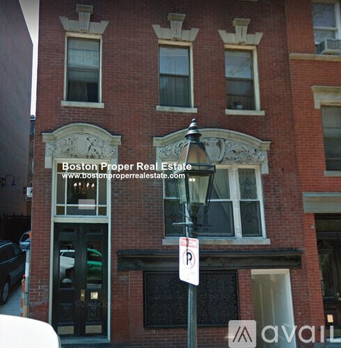 A building with a sign that says Boston Proper Real Estate.