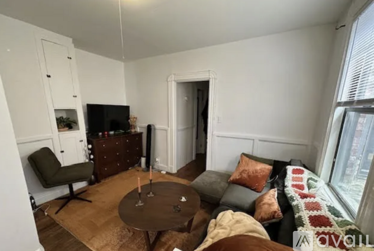 A living room with a brown table and a grey couch.