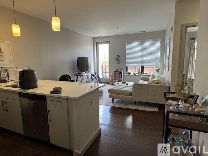 A kitchen with white cabinets and a black dishwasher.