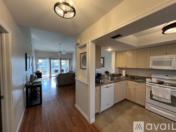 A kitchen with white appliances and wooden cabinets.