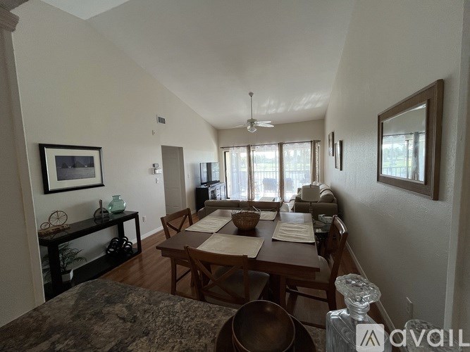 A dining room with a table set for a meal.