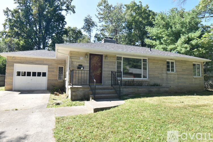A deer is standing in front of a house.