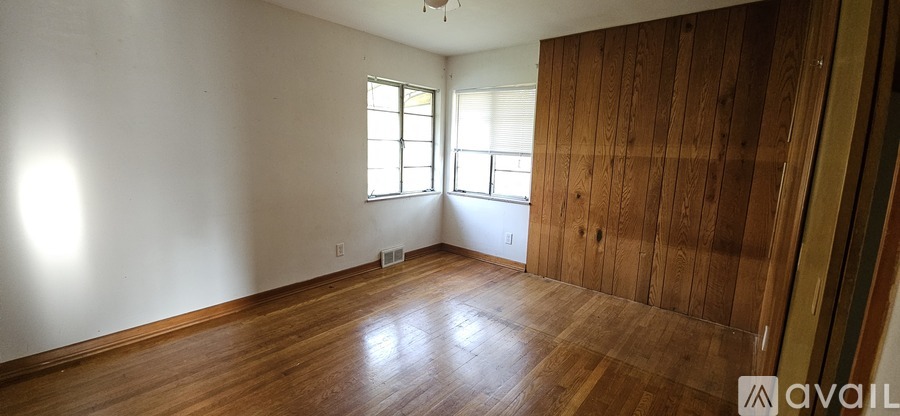 A room with wooden floors and a window.