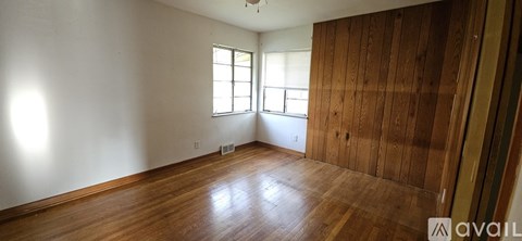 A room with wooden floors and a window.