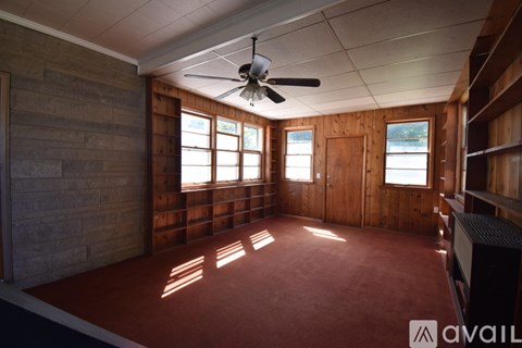 A room with a lot of storage space and a concrete wall.