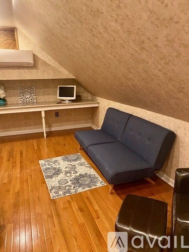 A living room with a blue couch and a television.