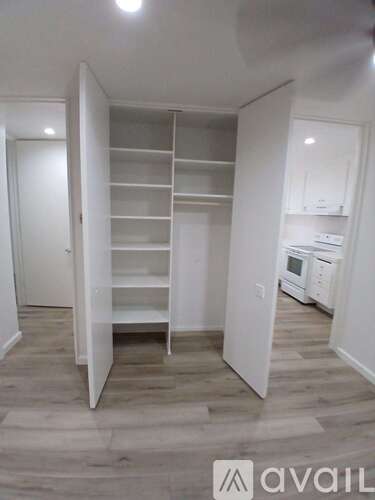 A kitchen with a white cabinet and a white oven.