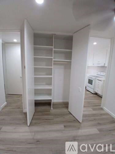 A kitchen with a white cabinet and a white oven.