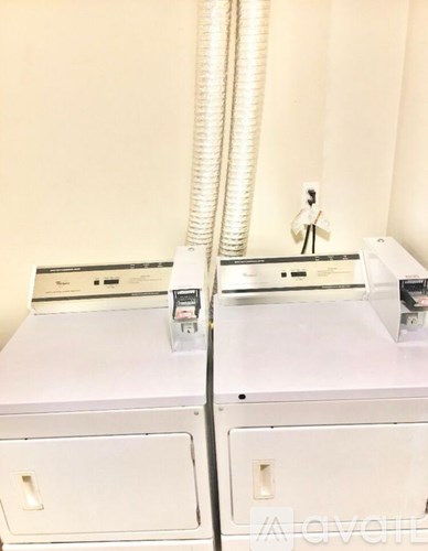 A white dryer and washer sitting next to each other.