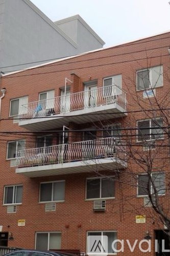 A red brick building with a balcony on the second floor.