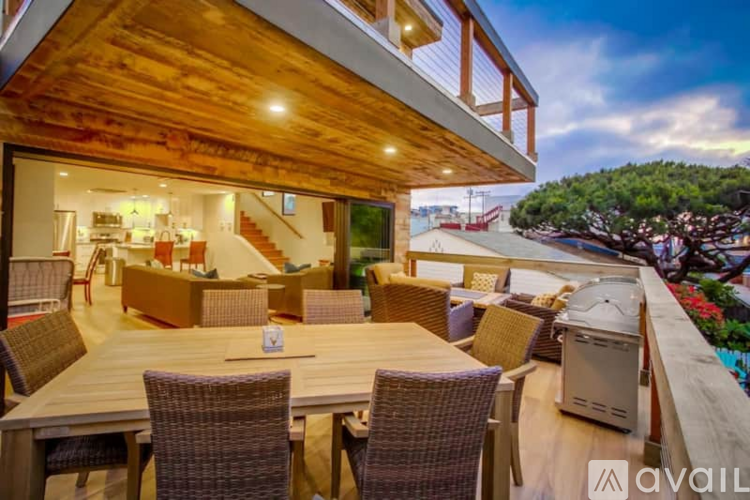 A modern house with a balcony and a hot tub.