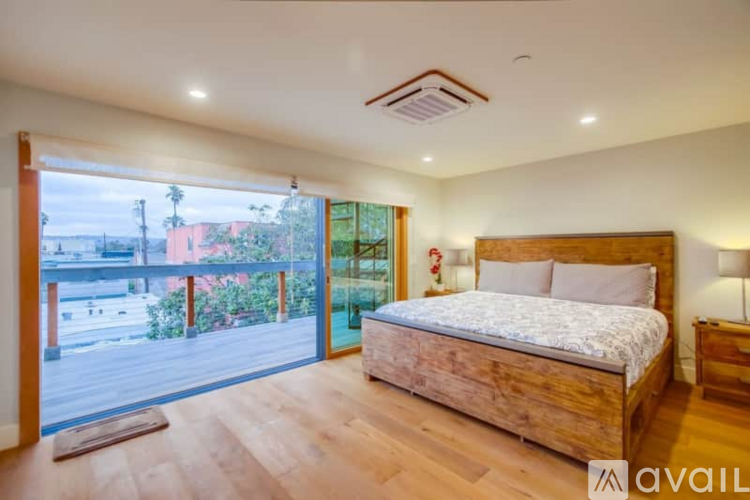 A modern kitchen with stainless steel appliances and wooden floors.