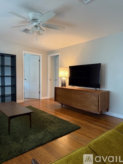 A living room with a television and a wooden cabinet.