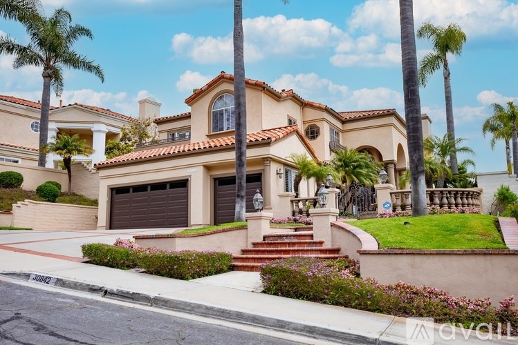 A house with a red tile roof and a garage door.