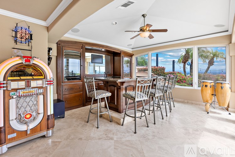 A room with a table and chairs and a jukebox.