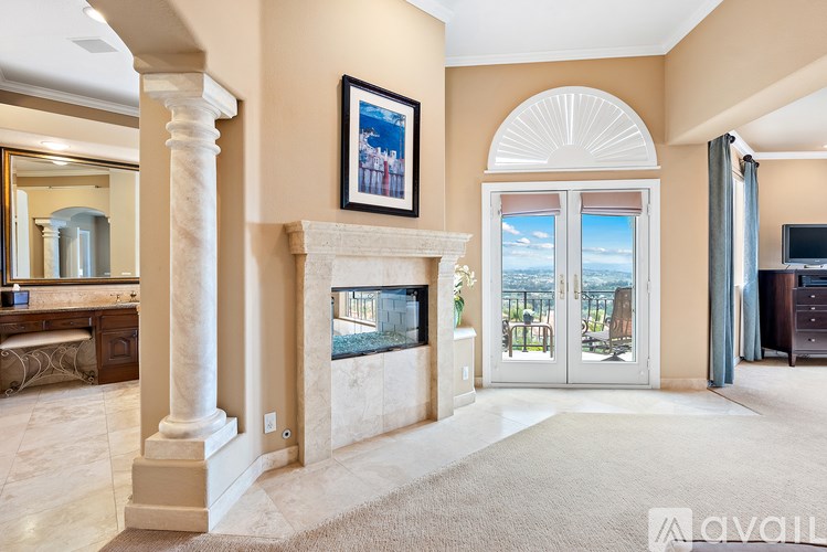 A living room with a fireplace and a painting on the wall.