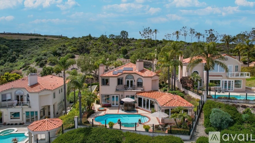 A large house with a pool in the backyard.