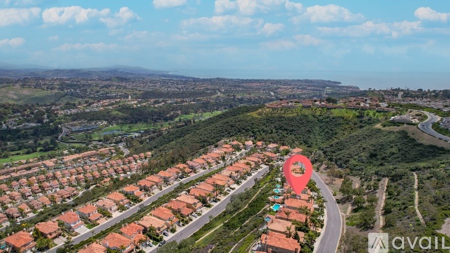 A bird's eye view of a residential area with a road and houses.