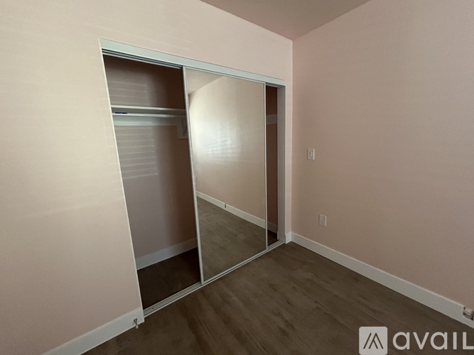 A room with a washer and dryer stacked on top of each other.