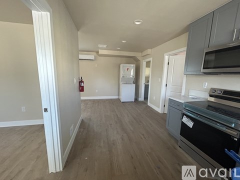A kitchen with a stove top oven and a refrigerator.