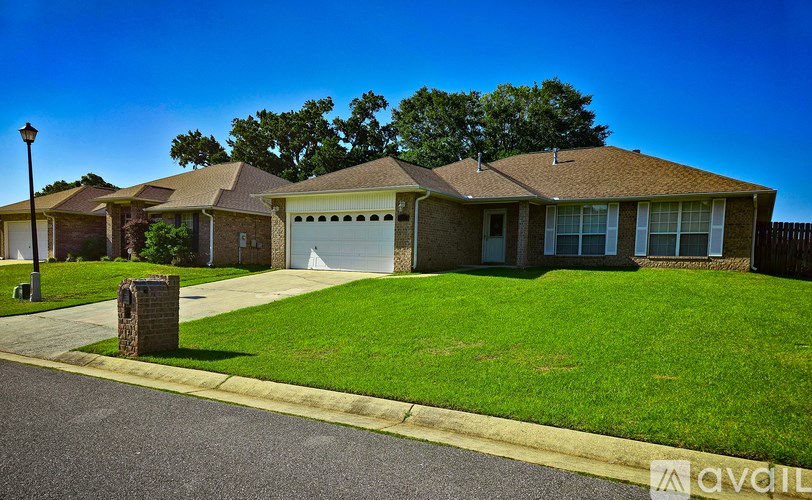 A house with a brown roof and a white garage door is for sale.