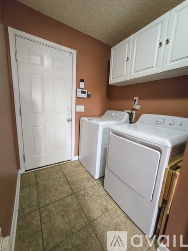 A small laundry room with a washer and dryer.