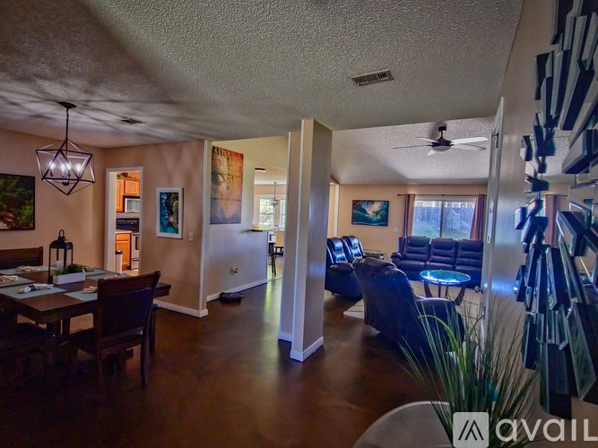 A living room with a dining table and chairs.