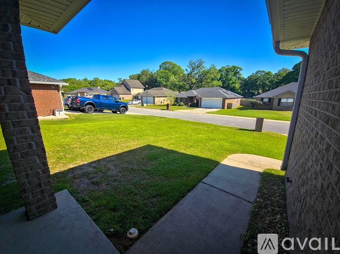 A blue truck is parked in a driveway.