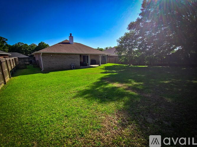 A house with a green lawn in front of it.
