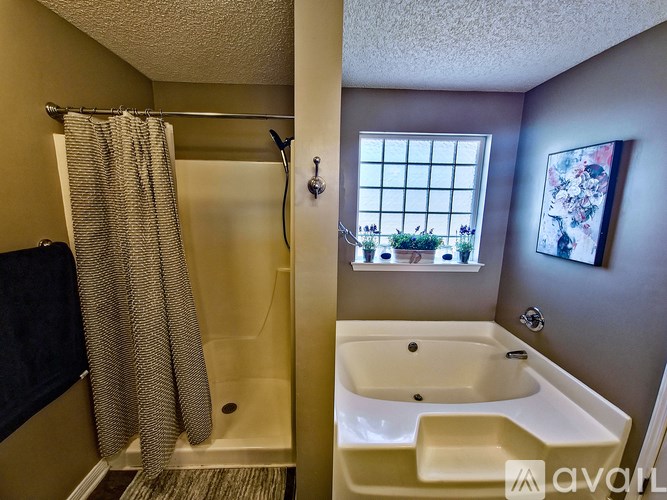 A bathroom with a tub and shower.