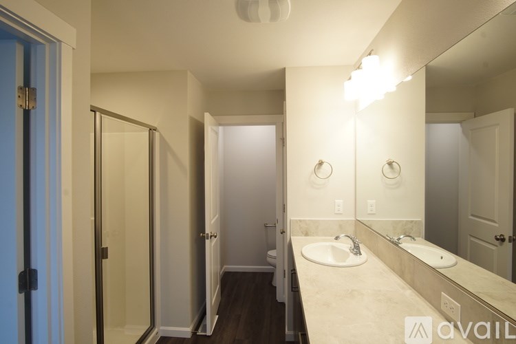 A bathroom with a sink, mirror, and toilet.