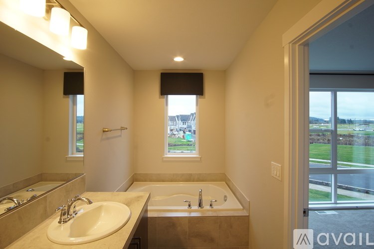 A bathroom with a sink, mirror, and tub.