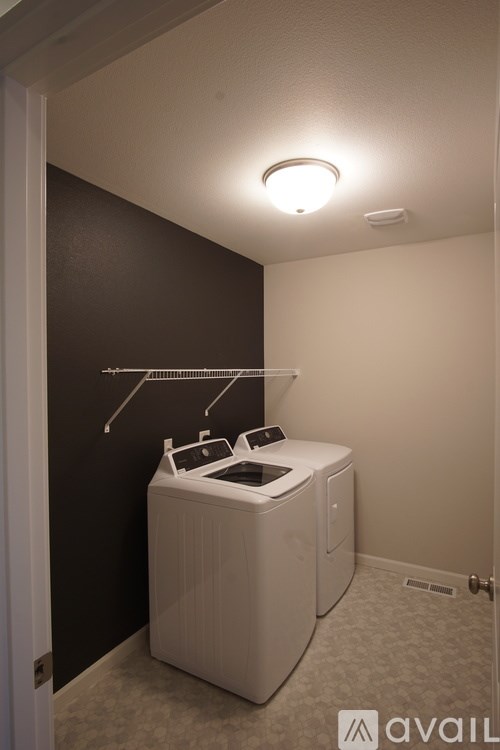 A white washing machine in a small laundry room.