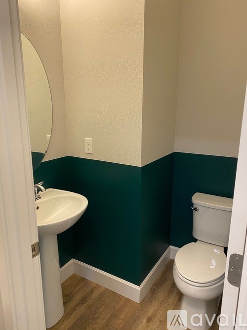 A white toilet sits next to a sink in a bathroom.