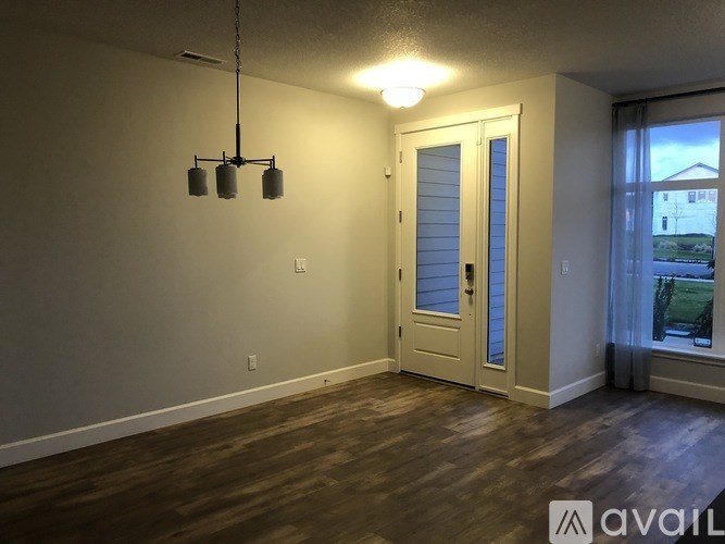 A room with a door, a window, and a light fixture.