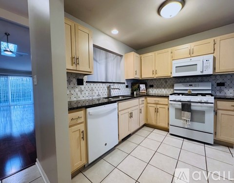 A kitchen with wooden cabinets and white appliances.