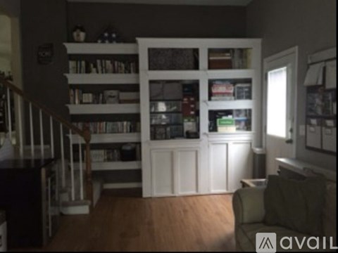 A living room with a couch and a bookshelf.