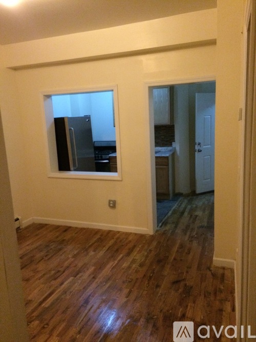 A room with wooden floors and a window.