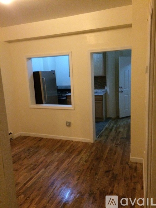 A room with wooden floors and a window.