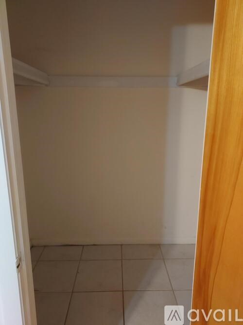 A room with a white door and a white wall.