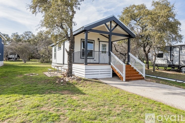 A small house with a porch and a covered entrance.