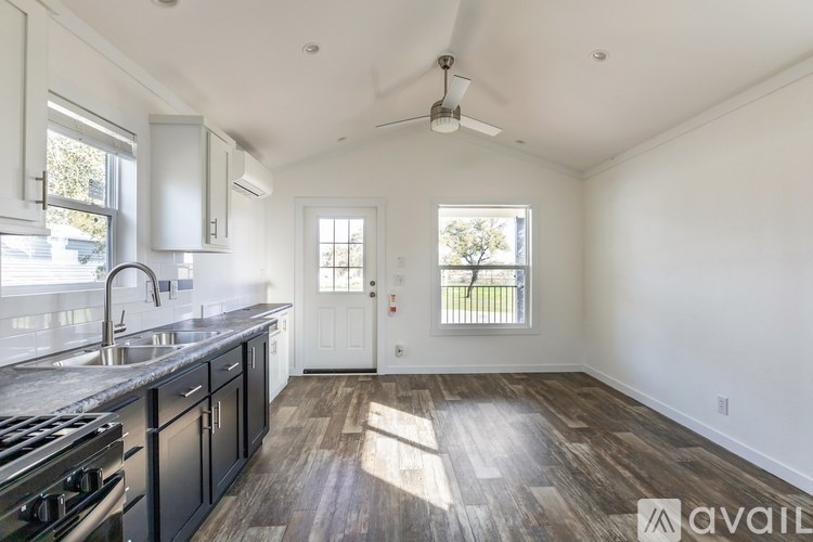 A kitchen with a stove top oven and a sink.