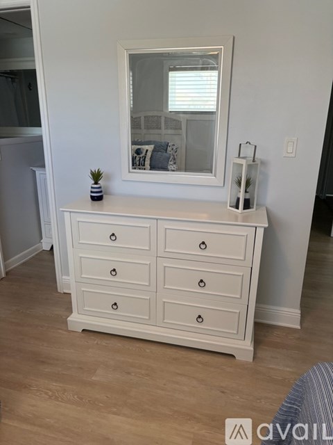 A swimming pool in front of a yellow building.