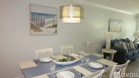 A dining room with a table set for a meal.