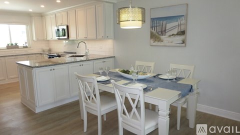 A kitchen with a dining table set for two.