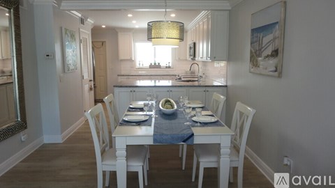A dining room with a table set for a meal.