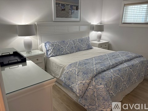 A kitchen with white cabinets and a granite countertop.