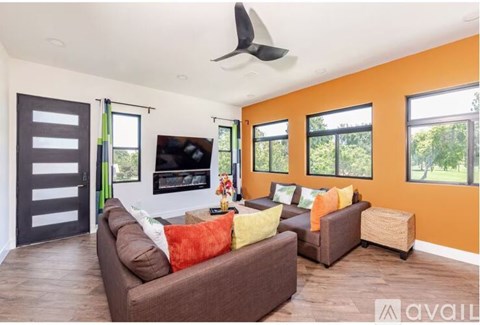 A living room with a brown couch and a television.