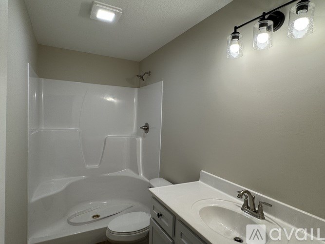 A bathroom with a white tub, toilet, and sink.